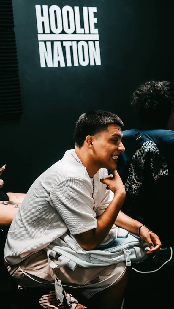 Artist laughing on a couch at a Hoolie Nation session